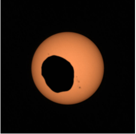 Orange circle, which is the Sun, with a dark circular object in front of it